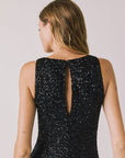 Back view of woman wearing Chaser’s Faye True Black Dress on a white background