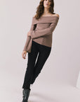 Full body view of woman wearing Chaser’s Pixie Deep Taupe Long Sleeve with black pants and boots on a white background