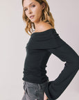 Side view of woman wearing Chaser’s Pixie True Black Long Sleeve with off-shoulder neckline on a white background
