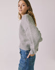 Side view of woman wearing Chaser’s Heather Grey Luck Zip Up Cardigan Sweater on a white background
