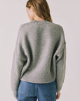 Back view of woman wearing Chaser’s Heather Grey Luck Zip Up Cardigan Sweater on a white background
