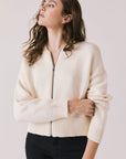 Front view of woman wearing Chaser’s Warm White Luck Zip Up Cardigan Sweater on a white background