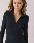 Front view of woman wearing Chaser’s Lara True Black Mini Dress with long sleeves on a white background