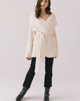 Full body view of woman wearing Chaser’s Eclipse Warm White Cardigan Robe styled with black jeans and boots on a white background