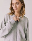 Front view of woman wearing Chaser’s Kiki Heather Grey Zip Up Hoodie on a white background