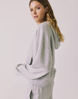 Side view of woman wearing Chaser’s Kiki Heather Grey Zip Up Hoodie with matching Daze Heather Grey Joggers on a white background