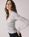 Side view of woman wearing Chaser’s Tilly Python Print Long Sleeve on a plain background