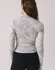 Back view of woman wearing Chaser’s Tilly Python Print Long Sleeve on a plain background