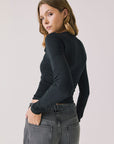 Back view of woman wearing Chaser’s Tilly True Black Long Sleeve on a plain background
