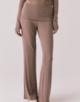 Front view of woman wearing Chaser’s Deep Taupe Mantra Legging on a plain background