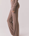 Side view of woman wearing Chaser’s Deep Taupe Mantra Legging on a plain background