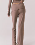 Back view of woman wearing Chaser’s Deep Taupe Mantra Legging on a plain background