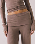 Front view of woman wearing Chaser’s Deep Taupe Mantra Legging on a plain background