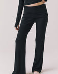 Front view of woman wearing Chaser’s True Black Mantra Legging on a plain background