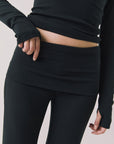 Front view of woman wearing Chaser’s True Black Mantra Legging on a plain background
