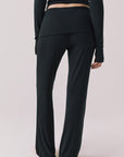 Back view of woman wearing Chaser’s True Black Mantra Legging on a plain background