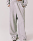 Front view of woman wearing Chaser’s Daze Heather Grey Joggers on a white background