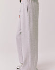 Side view of woman wearing Chaser’s Daze Heather Grey Joggers on a white background