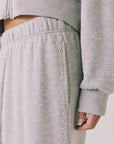 Side view of woman wearing Chaser’s Daze Heather Grey Joggers and sequin details on a white background