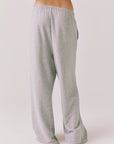Back view of woman wearing Chaser’s Daze Heather Grey Joggers on a white background