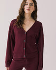 Front view of woman wearing Chaser’s Purple Fig Maison Cardigan Sweater on a white background