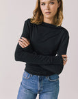 Front view of woman wearing Chaser’s Owen True Black Long Sleeve top with a relaxed fit and crew neckline on a light gray background