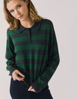 Front view of woman wearing Chaser’s Boyfriend Timeless Stripe Pullover with green and blue stripes on a plain background.