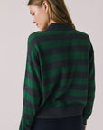 Back view of woman wearing Chaser’s Boyfriend Timeless Stripe Pullover with green and blue stripes on a plain background.