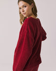 Back view of woman wearing Chaser’s Miller Purple-Red Fig Pullover Sweater on a white background