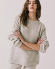 Front view of woman wearing Chaser’s Miller Heather Grey Pullover Sweater on a white background