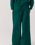Back view of woman wearing Chaser’s Hazel Joggers in Blue Grass Green on a white background