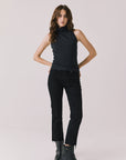 Full body view of woman wearing Chaser’s Hailee Black Tank with black pants and boots on a white background