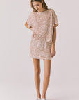 Full body view of woman wearing Chaser’s Jayde Bronze Brown Mini Skirt with matching Davis Bronze Brown Tee on a light gray background