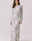 Full body view of woman wearing Chaser’s light Opal Python Print Maxi Dress with long sleeves, a subtle snakeskin design and relaxed fit against a white background