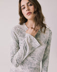 Front view of woman wearing Chaser’s light Opal Python Print Maxi Dress with with long sleeves and a subtle snakeskin pattern against a white background
