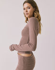 Side view of woman wearing Chaser’s Porta Deep Taupe Long Sleeve top on a white background