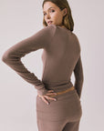 Back view of woman wearing Chaser’s Porta Deep Taupe Long Sleeve top on a white background