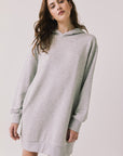 Woman wearing Chaser's Aster Heather Grey Hoodie Dress on a plain background