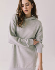 Woman wearing Chaser's Aster Heather Grey Hoodie Dress on a plain background