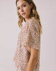 Side view of woman wearing Chaser’s Davis Bronze Brown Tee on a light gray background