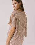 Back view of woman wearing Chaser’s Davis Bronze Brown Tee and matching Jayde Bronze Brown Mini Skirt on a light gray background