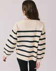 Back view of woman wearing Chaser’s striped Merci Long Sleeve Sweater on a white background