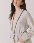 Side view of woman wearing Chaser’s Cozy Heather Grey Robe with tie waist on a white background