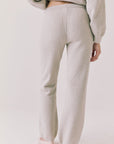 Back view of woman wearing Chaser’s Monica Heather Grey Joggers on a white background