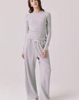Full body view of woman wearing Chaser’s Spritz Long Sleeve with matching Brandy Light Heather Grey Joggers on a white background