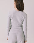 Back view of woman wearing Chaser’s Spritz Long Sleeve on a white background