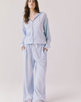 Woman wearing the Abilene Light Skyway Blue Zip Up Hoodie with matching pants on a white background