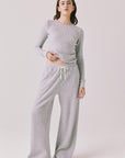 Full body view of woman wearing Chaser’s Brandy Light Heather Grey Joggers with matching Spritz Long Sleeve on a white background.