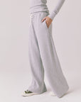 Side view of woman wearing Chaser’s Brandy Light Heather Grey Joggers on a white background