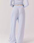 Back view of woman wearing Chaser’s Brandy Skyway Blue Joggers on a white background